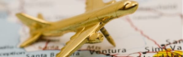 金色の飛行機の模型が地図の上に置かれている